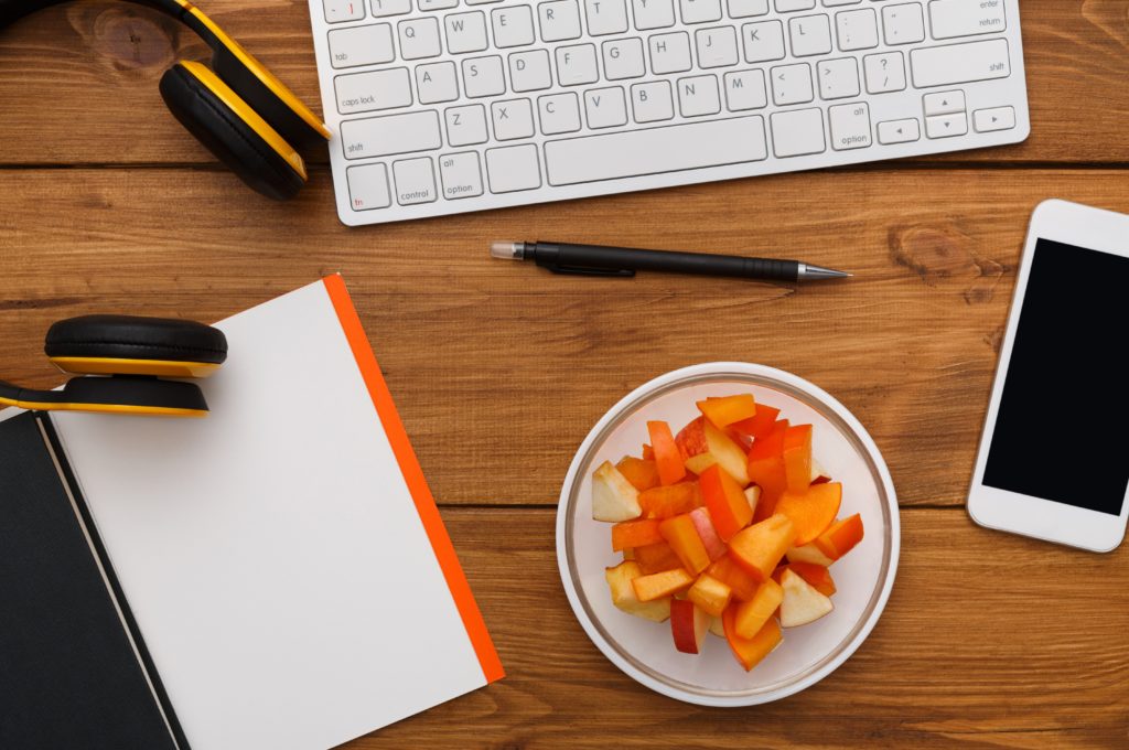 A healthy office environment with fruit on the table, a representation of how to lose weight with a desk job