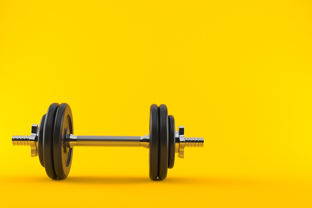 A black and silver dumbbell with a yellow background- The 7 day weight loss exercise plan variety