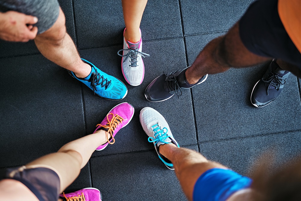 Multi colored gym shoes together in a circle- 7 day challenge exercise session