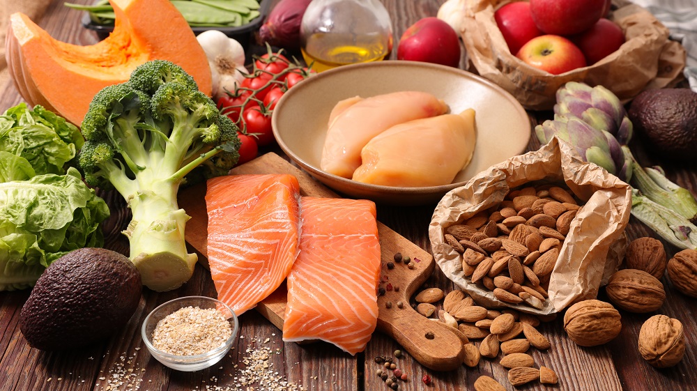 Super healthy whole foods on a wooden surface- Showing the types of foods that are in the 7 day diet plan for weight loss